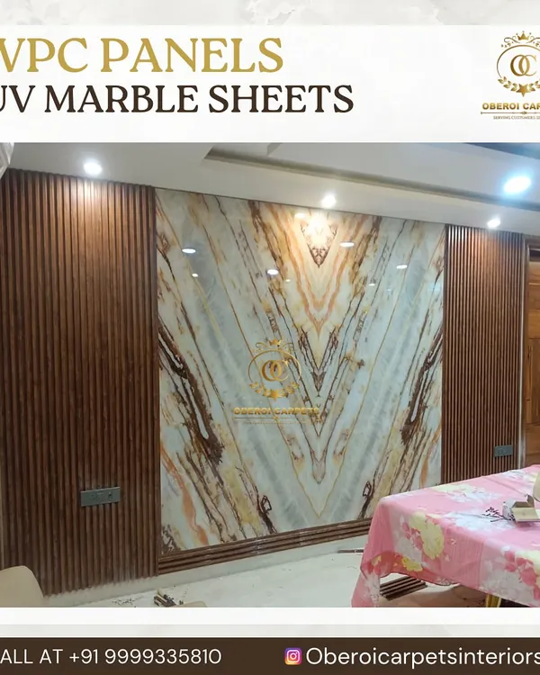 This stunning feature wall combines the warmth of wood-grain WPC panels with the elegance of a book-matched UV marble sheet. The V-pattern of the marble creates a dynamic and luxurious focal point in the dining area.