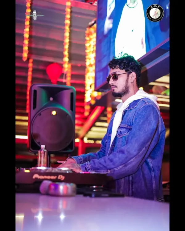 Focused on the mix, blending tracks at the Pioneer console. This is where the art of DJing happens.