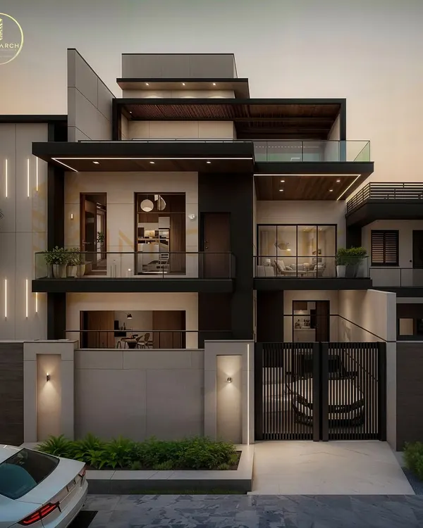 This is a 3D visualization of an upcoming modern luxury villa in Gwalior. The design features a dynamic play of volumes, clean lines, and a mix of materials, complete with integrated lighting that highlights its architectural features at dusk.