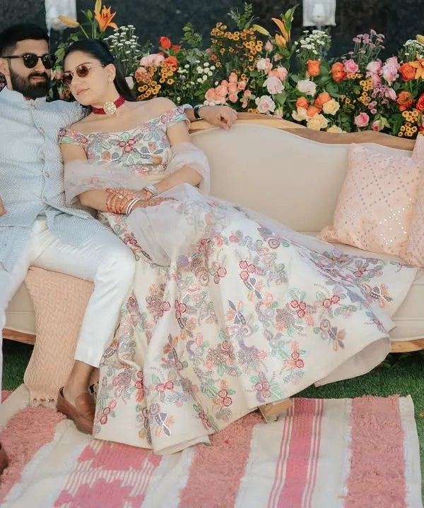 For a 'Nazar Na Lage' themed welcome lunch in Jaipur, the couple relaxes against a backdrop of vibrant, fresh flowers. The setting blends royal Rajasthani charm with relaxed, modern elegance.