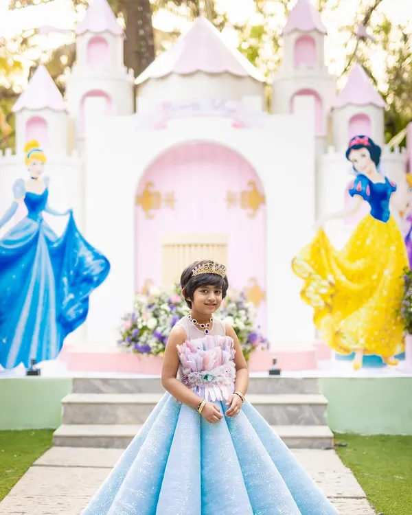 The birthday girl, Princess Aadhya, looking absolutely regal in front of the castle I designed for her. My setups provide the perfect photo opportunity to capture these precious memories.