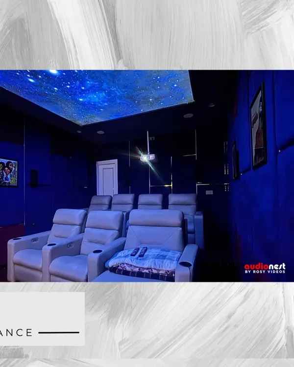 A view of our KEF T301 series home cinema installation. The starry ceiling, deep blue acoustic panels, and comfortable recliners create the perfect ambiance. This setup is designed for pure cinematic escapism.