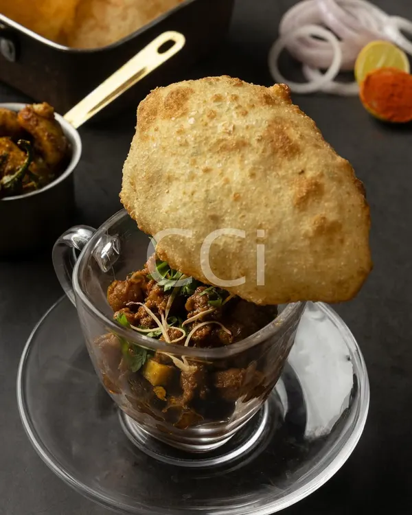 Our signature take on Chole Bhature, designed for elegant events. The spicy chickpea curry is served in a clear glass, with a crisp, golden bhatura placed on top, offering a clean, sophisticated way to enjoy this classic Punjabi dish.