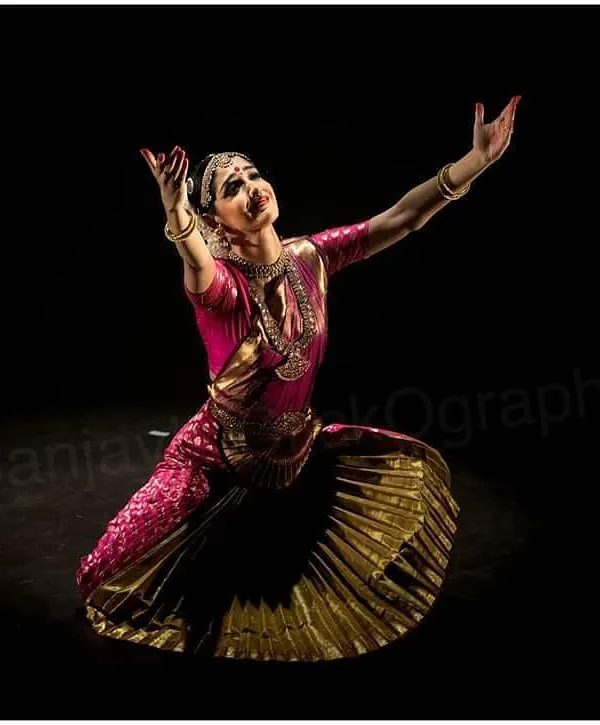 A moment of complete surrender and devotion during a solo Bharatanatyam performance. The dramatic lighting by photographer Sanjay Kaul highlights the sculptural quality of the pose.