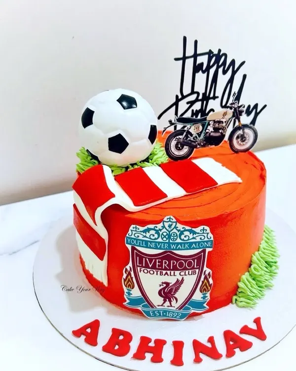 Celebrating in true Liverpool style with this football-themed cake, complete with the team scarf and a motorcycle for the birthday boy's other passion.