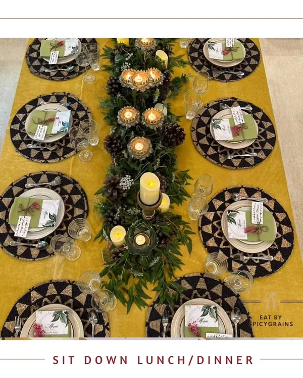 An overhead view of our elegant sit-down dinner setup. The table is beautifully styled with custom placemats, a lush centerpiece, and ambient candlelight for a truly luxurious experience.