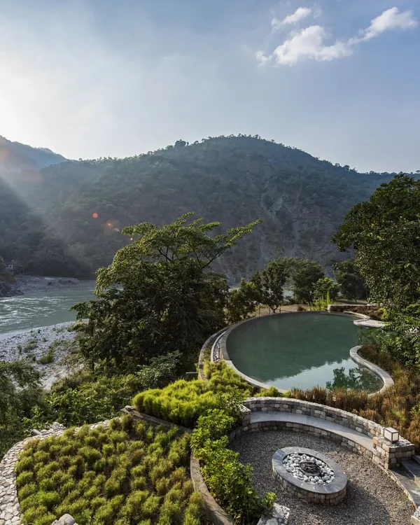 A view of the infinity pool at the Taj Rishikesh resort, overlooking the Ganges river and Himalayan foothills. This project embodies our principle of sustainable luxury, where modern comfort is seamlessly integrated into its natural landscape.