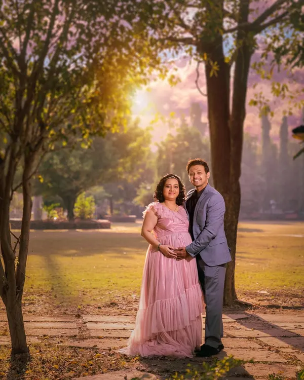 An outdoor maternity photoshoot set against the soft, warm light of a park. These sessions are relaxed and focus on your connection as a couple before your little one arrives.