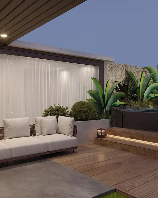 A view of the Gurugram terrace project, showing the comfortable lounge seating next to the elevated pool deck. The design ensures a smooth transition from the indoor space to the outdoor lounge.