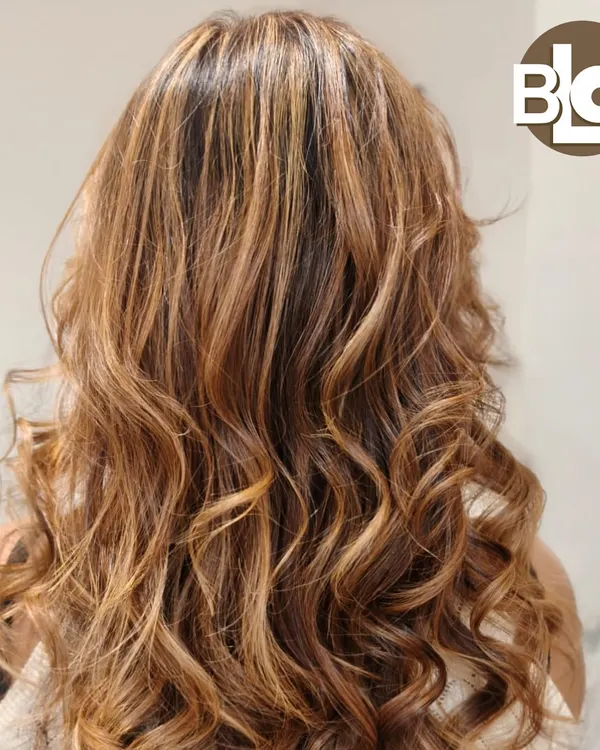 A perfect example of a sun-kissed balayage on long hair. We blended these tones seamlessly to create a natural, flowing look that shines from every angle.