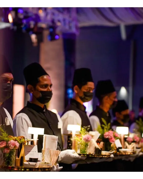 A line of our service staff, uniformly dressed and ready for a grand engagement event, symbolizing our commitment to organized and impeccable service.