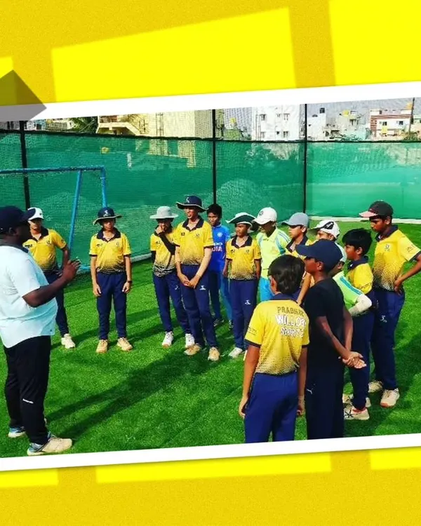 A group of young players getting instructions from a coach during our summer camp. Our camps are designed to be fun, engaging, and highly educational.