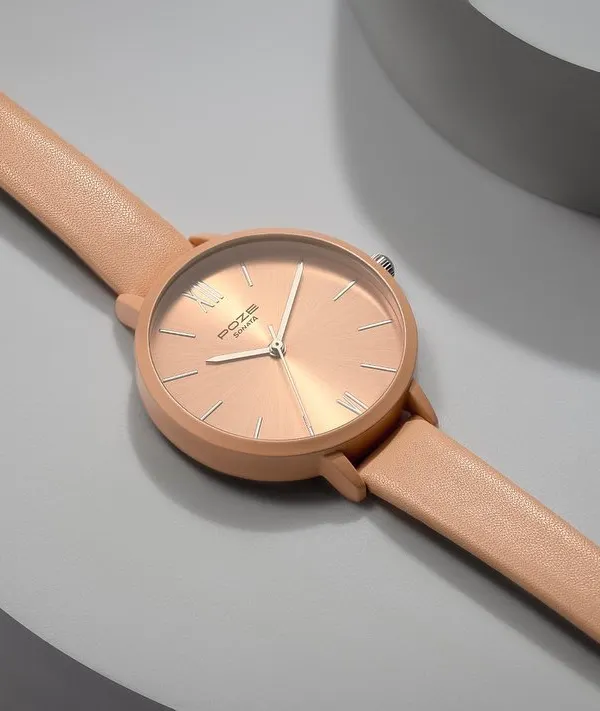 Product styling for a Sonata watch in a soft blush tone. I used curved, neutral-colored props to create a gentle, minimalist background that complements the watch's feminine design and color.