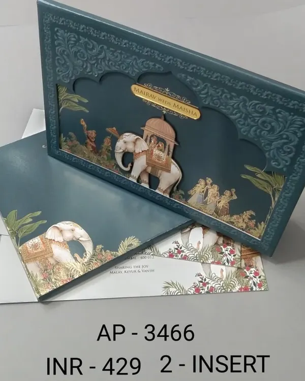 This deep teal invitation makes a bold statement with its unique jharokha-style frame and a three-dimensional royal elephant. The gold foil accents and intricate details make it a luxurious choice for a memorable wedding announcement.