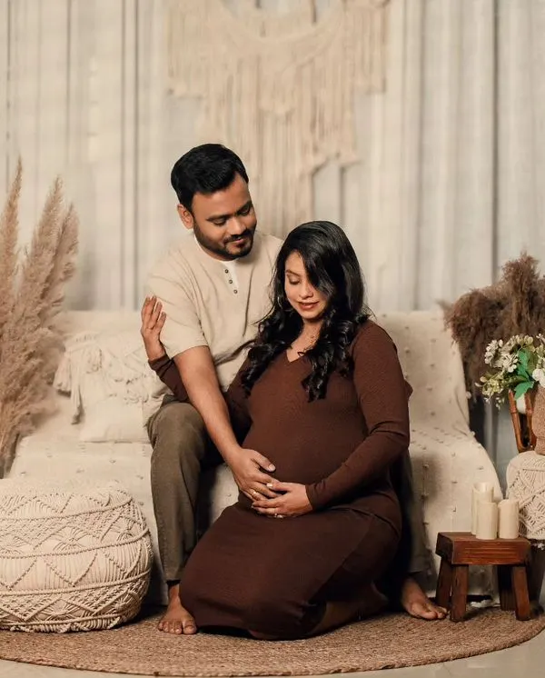 A full view of my cozy, bohemian-themed studio setup, featuring a couple in earth tones surrounded by pampas grass, macrame, and soft lighting.