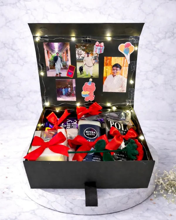 This birthday hamper is a surprise waiting to happen. The box lid is lined with photos and fairy lights, and the inside is filled with chocolates and other gifts for him.