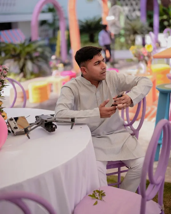 At a wedding event, but my focus is on the next flight. Here I am with my trusty DJI Mavic 3, ready to capture the action from above. If I can't bring my drone, I'm not coming.
