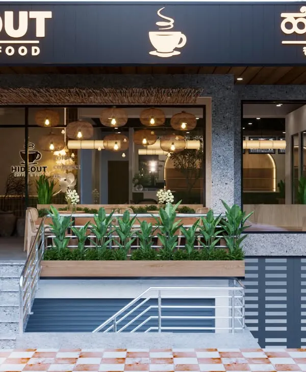 This is how we make a first impression. For Hideout Cafe in Bangalore, we designed an exterior that is open and inviting, giving passersby a clear view of the warm, nature-inspired ambiance waiting inside. The combination of modern signage, lush greenery, and a glimpse of the rustic interior lighting creates instant curb appeal.