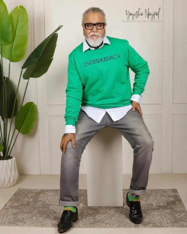 Makeup for the celebrity actor Dinesh Mohan. This look complements his trendy outfit, focusing on clean skin and defined features for a sophisticated and statement-making appearance.