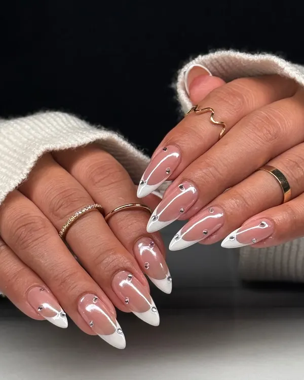 The full two-hand view of this glamorous French manicure. The almond shape, clean white tips, and scattered silver gems create a look that is both classic and modern.