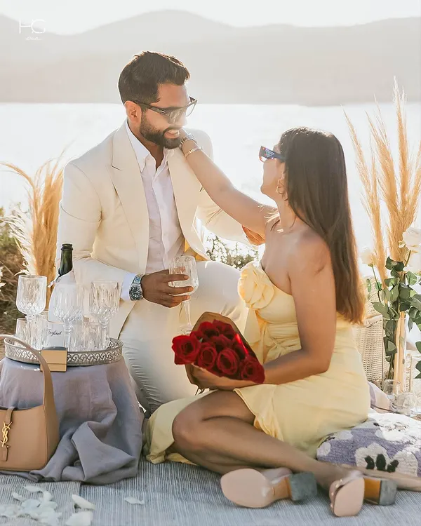 A beautiful moment captured during a celebration. My client wears a bespoke off-white suit, tailored to perfection for this romantic seaside picnic.