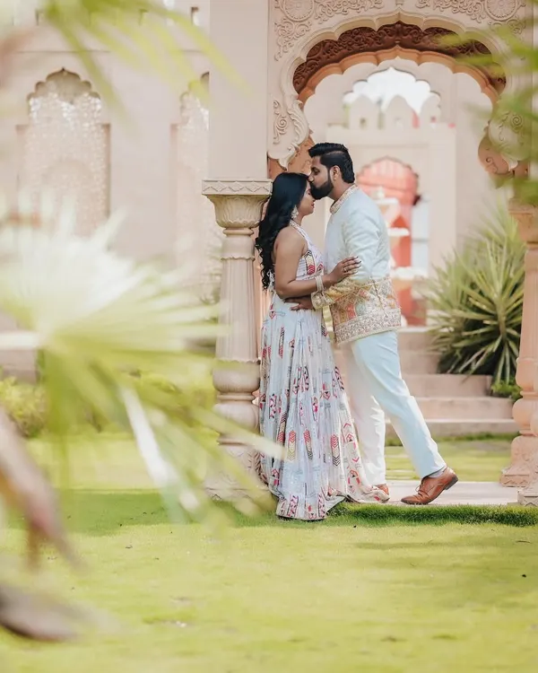 A fine-art portrait from a pre-wedding shoot at a location with stunning architecture. The composition and soft light create a truly romantic and regal photograph.