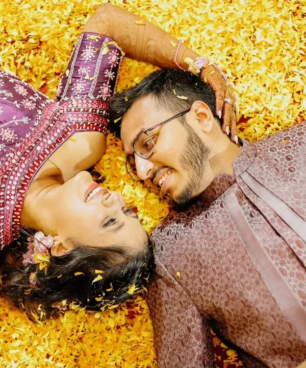 Lying in a bed of flowers, lost in their own world. This is one of my favorite ways to shoot a 'phoolon ki haldi', creating a romantic and dreamy portrait amidst the fun.