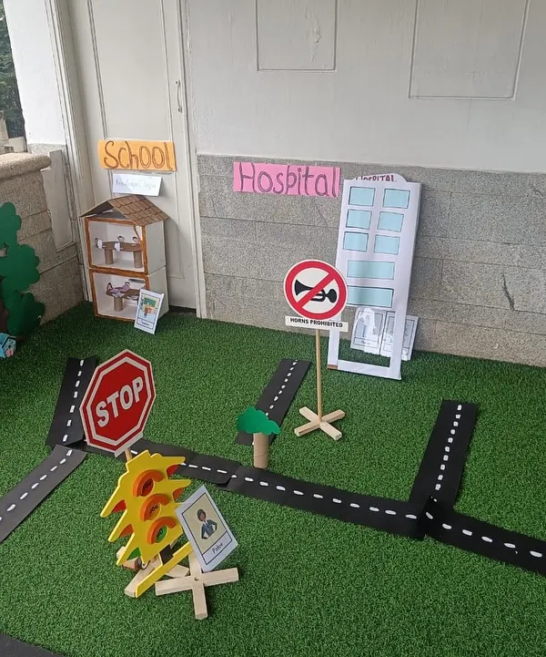This is our miniature community, set up for a month-long exploration of homes and neighborhoods. It includes a school, hospital, and roads, providing a rich environment for imaginative play.