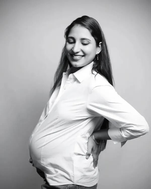 A simple white shirt and a genuine smile. This classic black and white studio portrait is all about capturing the pure joy and beauty of your pregnancy in a timeless way.