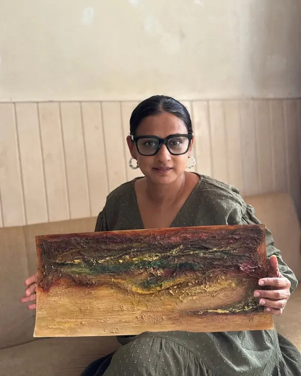 Here I am, sitting with one of my favorite textured art series. This piece features a rich, earthy palette and a landscape-like feel, created on paper.
