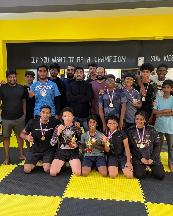 Our team celebrating together after an in-house tournament. This picture captures our spirit perfectly: a diverse group of kids and adults, proud of their efforts and happy for each other's success.