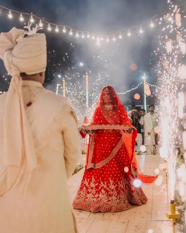 The bride's breathtaking entrance, walking towards the groom through a path of sparklers. This is a moment of pure magic and anticipation.