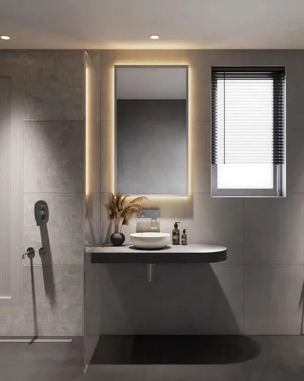 For this project, we combined two small bathrooms to create one spacious master bathroom. The design uses a grey color scheme with a mix of textures, shapes, and a backlit mirror to create a warm and versatile space.
