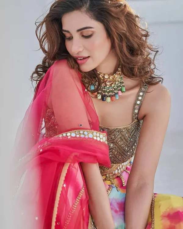 For this vibrant, multi-coloured lehenga, I kept the makeup glowing and fresh with a touch of colour on the lips. This look is ideal for a sangeet or mehendi ceremony.