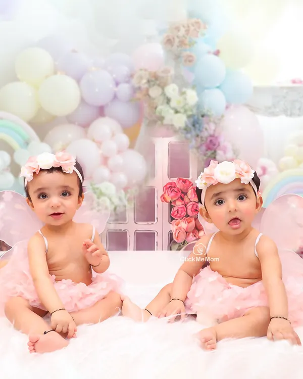 Two little fairies, twice the magic. This portrait of twin sisters in our pastel-themed fairy setup is a beautiful memory of their special bond.