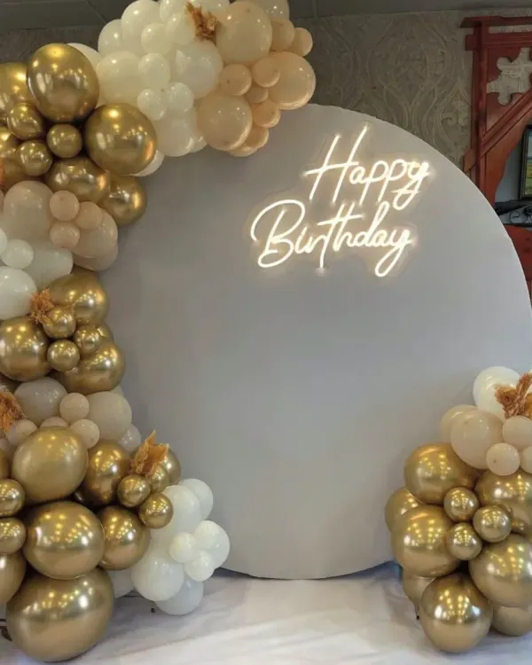 A stunning first impression with this elegant white and gold balloon arch. This classic and sophisticated setup is perfect for milestone birthdays, anniversaries, or any chic celebration, creating a beautiful photo backdrop.
