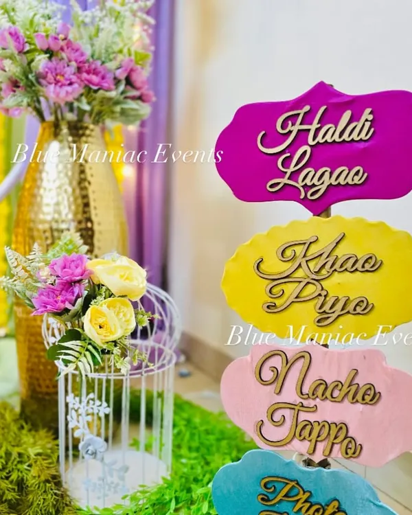 Fun and quirky props for your Haldi ceremony, with signs like 'Haldi Lagao', 'Khao Piyo', and 'Nacho Tappo' to get everyone in the festive spirit.