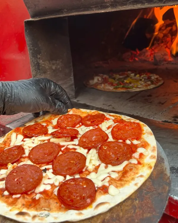 Here’s a look at my fiery oven where the magic happens. This pepperoni pizza is just about to go in, ready to be transformed into a crispy, cheesy masterpiece.
