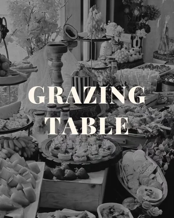 A grazing table is more than just food; it's an interactive centerpiece for your event. This black and white shot highlights the sheer abundance and intricate arrangement of our spreads.