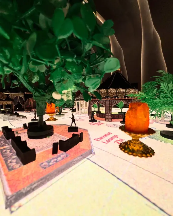 This is a miniature model I created for an 'Arabian Nights' theme. This first step is crucial for visualizing every detail, from the layout of the lounges to the placement of trees and props, ensuring the final design is perfect.