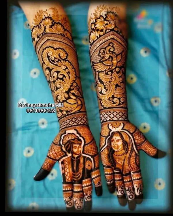 This is the kind of art I love to create for my brides. A full bridal mehndi design featuring incredibly detailed portraits of the bride and groom on the palms, complemented by elaborate paisley and peacock motifs extending up the arms.
