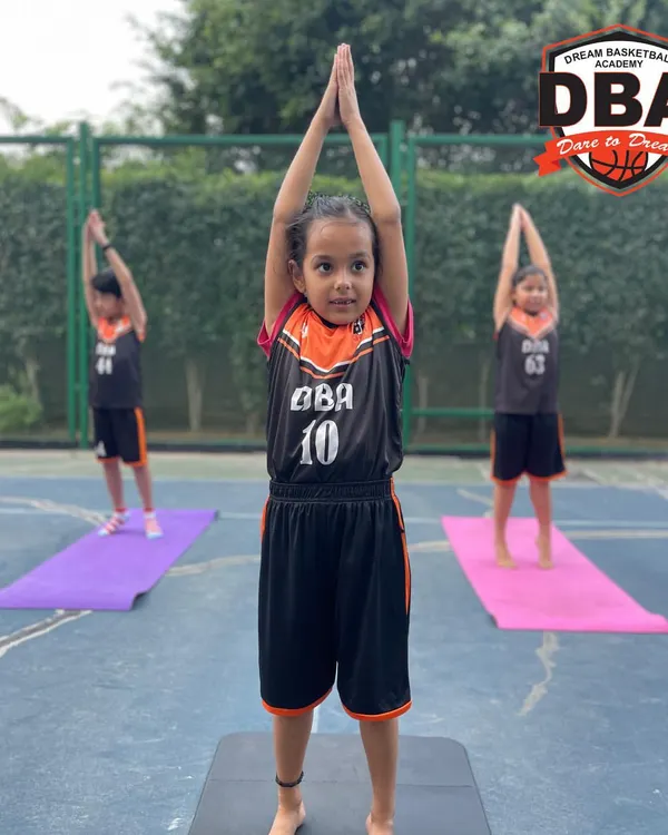 This is what focus looks like. A young DBA athlete holds a pose during our yoga session, building the mental discipline that translates directly to the basketball court.