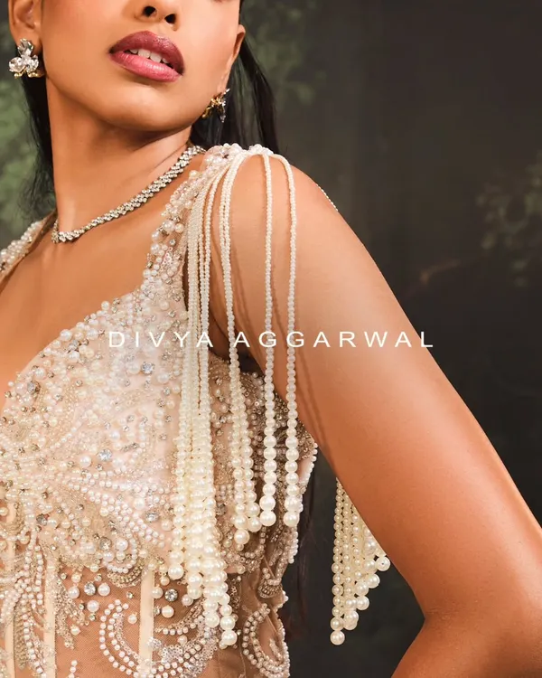 A macro shot of the Nuray Gown's shoulder detail. I designed these cascading tassels with hundreds of hand-strung pearls to create fluid, elegant movement.