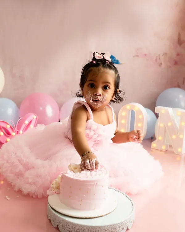 The cake smash begins. This little one is getting her first taste of birthday cake during her butterfly themed first birthday photoshoot in my Navi Mumbai studio.