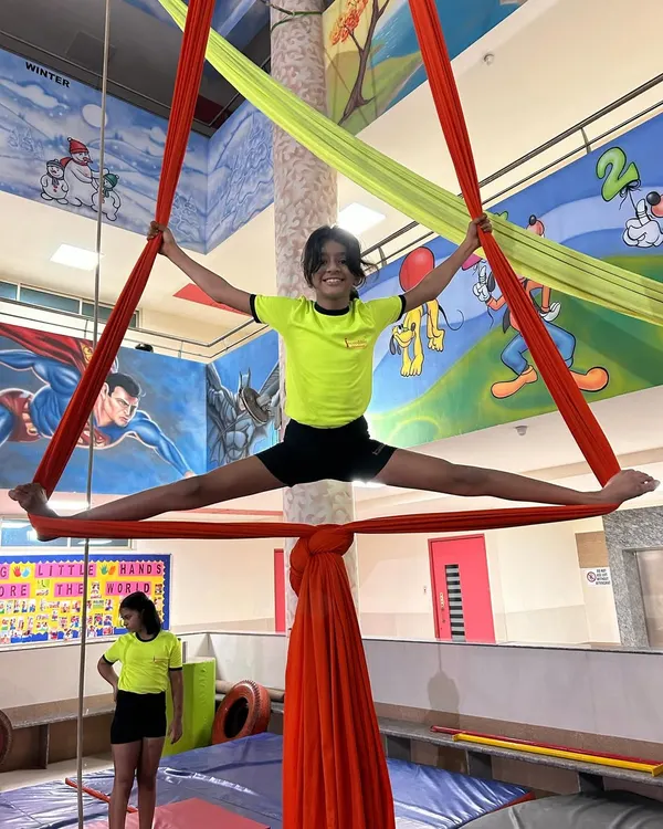 A perfect split held high on the silks demonstrates amazing flexibility and strength. Our classes focus on achieving these milestones safely and progressively.