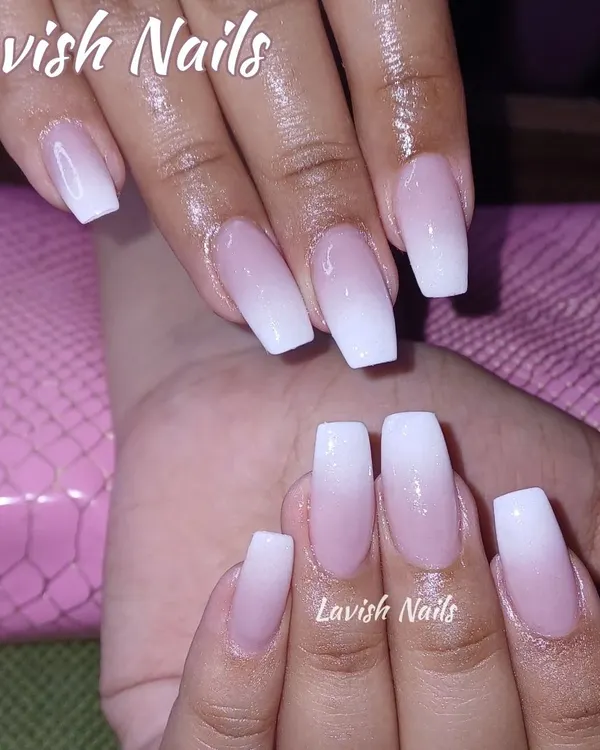 A perfect example of a classic baby boomer manicure, with a seamless pink-to-white ombre on long, coffin-shaped nails. This is a timeless and elegant choice.