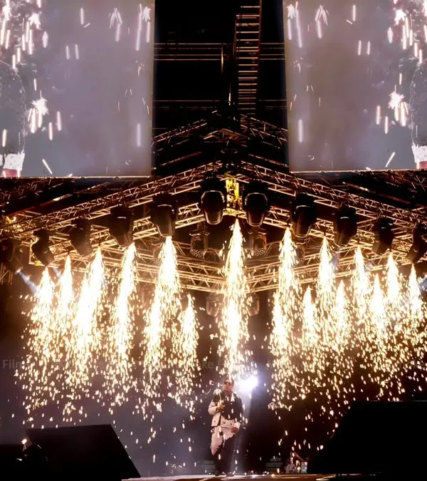 Capturing the peak moment of a concert, with stage pyrotechnics erupting as music legend Yuvan Shankar Raja performs.