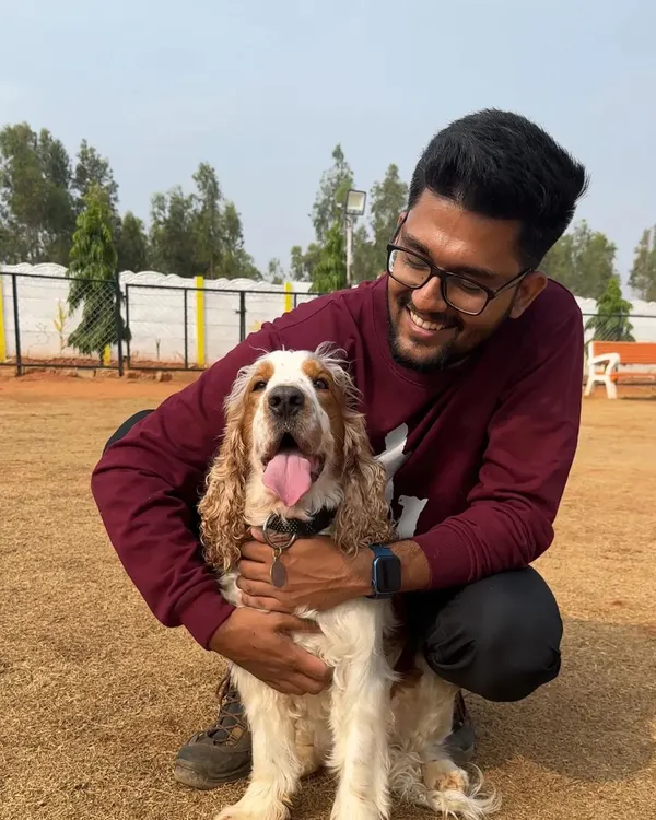 There's nothing better than a hug from a happy dog. Here I am with a beautiful Cocker Spaniel, sharing a smile after a fun play session in our daycare.