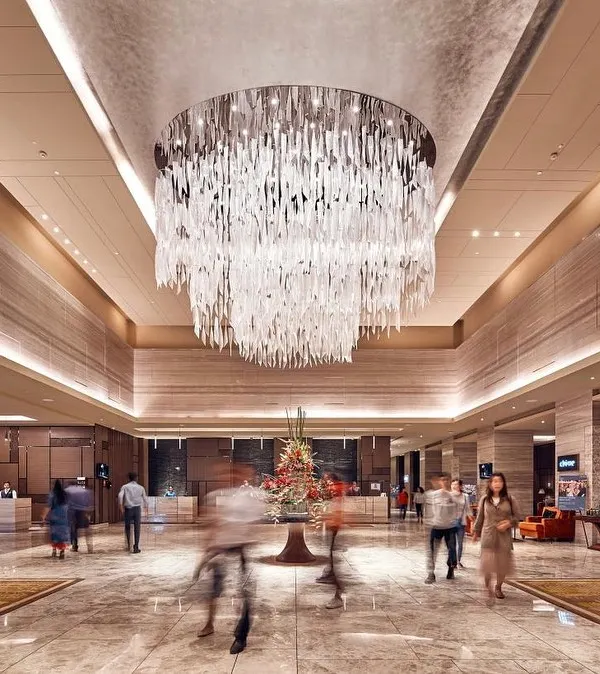 The lobby of the Sheraton, Bangalore, is defined by its soaring ceiling and this spectacular custom chandelier. We use such statement pieces to create a sense of arrival and luxury in our hotel interior designs.