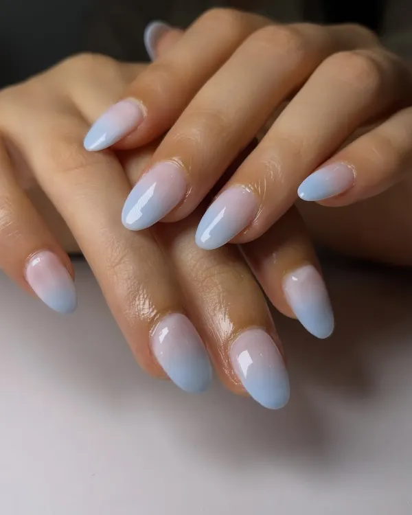 A perfect example of a seamless fade from a blush pink base to a soft baby blue tip. This is the art of the ombré, creating a gentle and beautiful color transition.